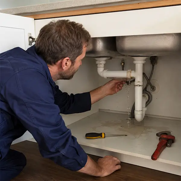 Fort Worth plumber repairing residential plumbing equipment